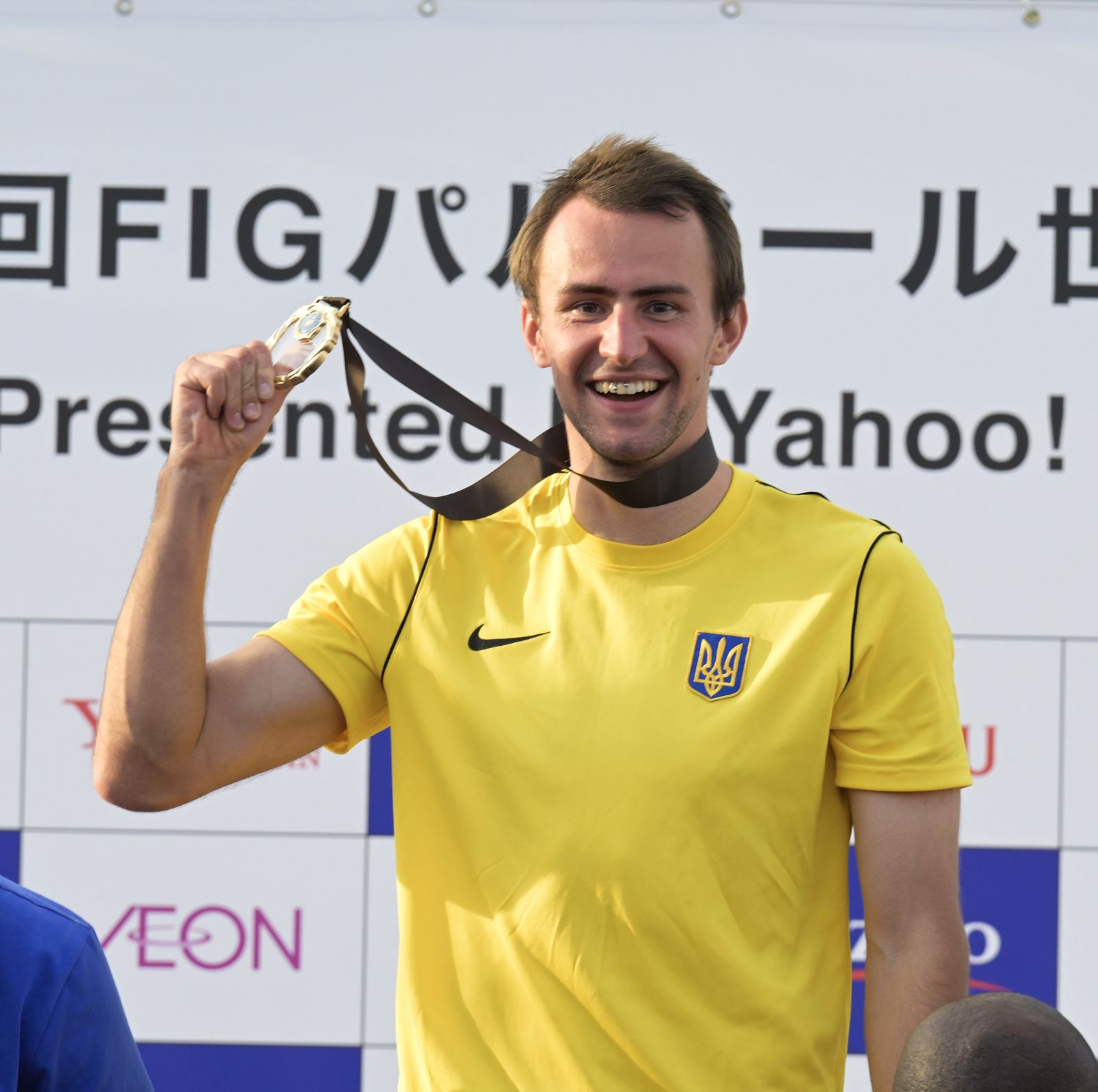 Parkour athlete Bohdan Kolmakov smiling with a gold medal in Tokyo