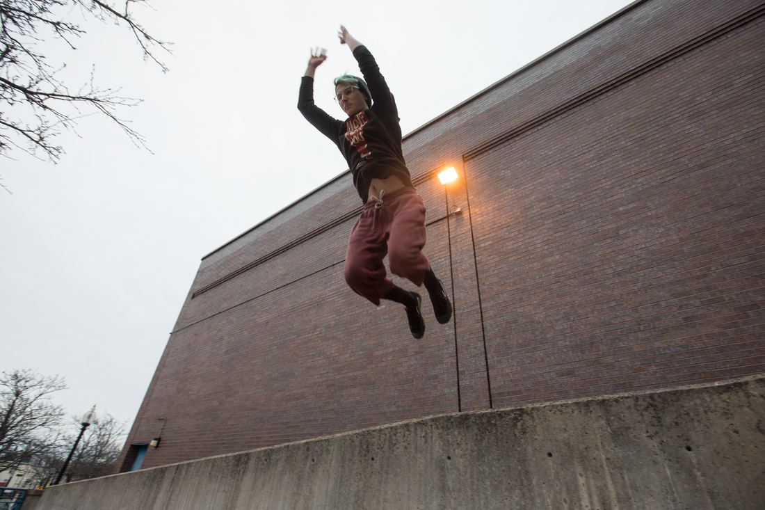 A parkour athlete landing a precision jump in Boston
