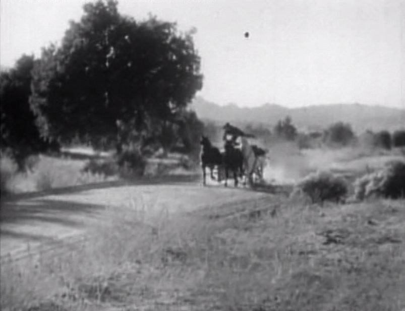 Stunt pioneer Yakima Canutt leaping from a horse to a moving wagon in an old western